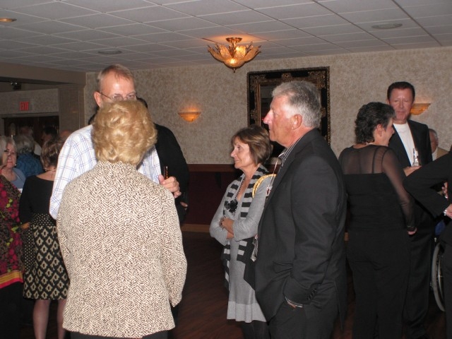 Homecoming queen and king, Jane Trakel & Dave Merryfield talking with Dennis Olson