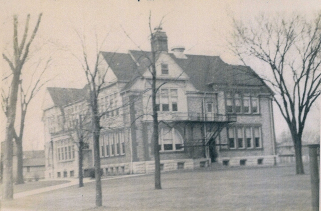 Hi Mike and classmates,  
I found this photo of the old Hadfield School.  Remember the coal bunker?  Remember the steep steps?  Most of us attended here from kindergarten through 4th grade.  Both of my parents went to this same school as well.  Did anyon